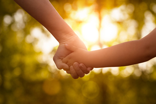 Mother and Child hold hands